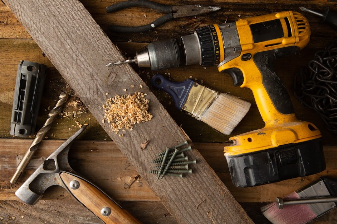Crafting Captivating Headlines: Your awesome post title goes here A variety of tools, including a hammer and cordless drill, sit on top of a table made of wood boards.